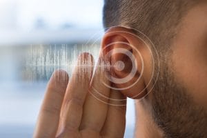 image of msp business owner holding their ear as if to be listening in closer